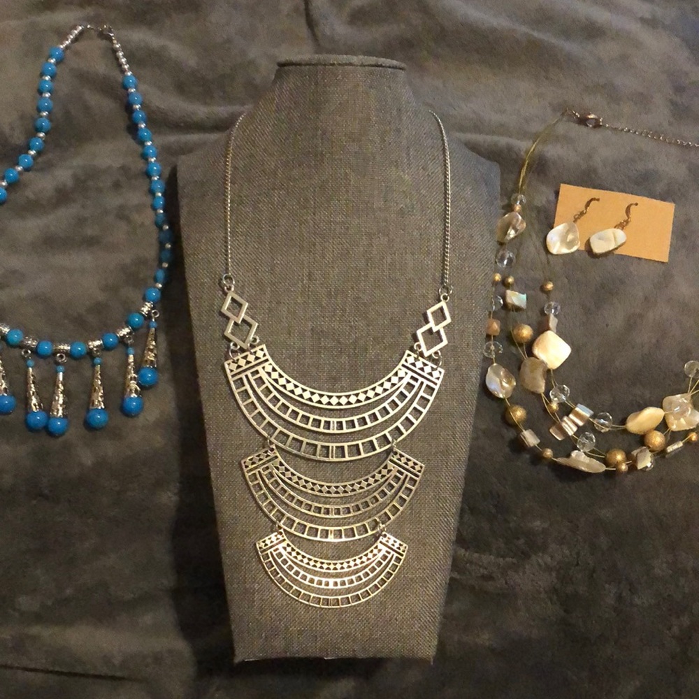 Three necklace very pretty. One shell and crystal wire necklace with earrings
